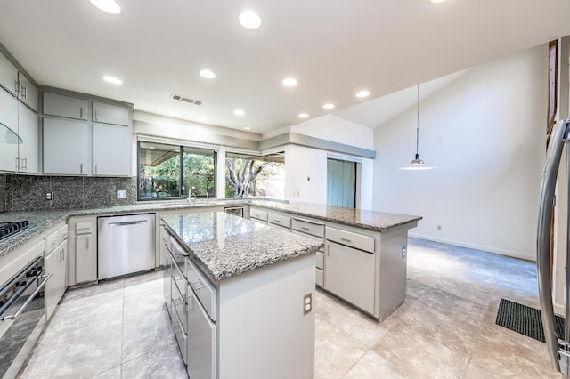 kitchen featuring gray cabinets, a center island, stainless steel appliances, and hanging light fixtures