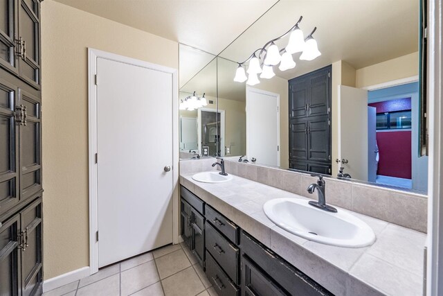 bathroom featuring tile patterned floors, a sink, and double vanity