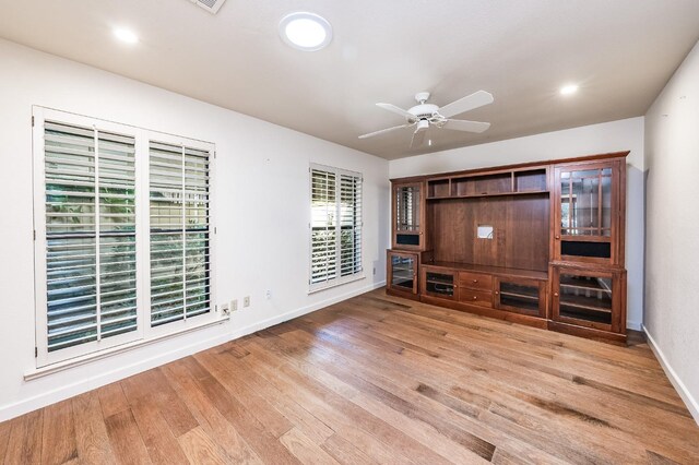 unfurnished living room featuring baseboards, wood finished floors, recessed lighting, and a ceiling fan
