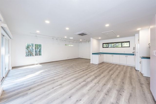 unfurnished living room featuring light hardwood / wood-style floors