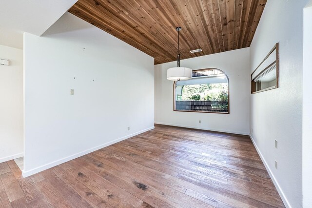 unfurnished dining area featuring wood-type flooring, wooden ceiling, baseboards, and visible vents