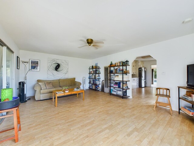 living room featuring light wood-type flooring and ceiling fan