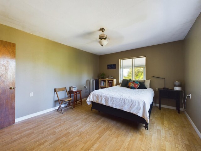 bedroom featuring ceiling fan and light hardwood / wood-style flooring