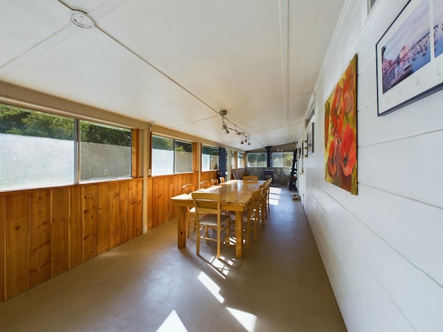 dining room with wood walls