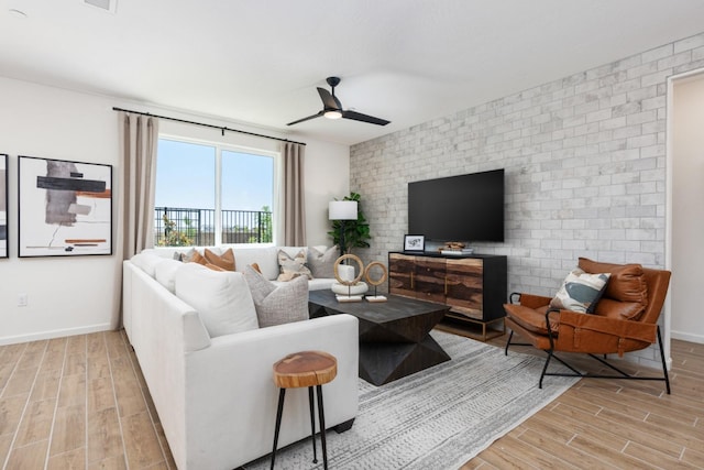 1625 Bloom Ave, Clovis, CA 93619 - living room with wood finished floors, ceiling fan, and brick wall