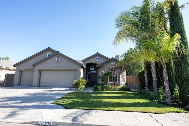 view of front of home with a garage and a front lawn