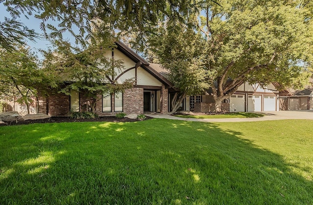 tudor home with a front lawn