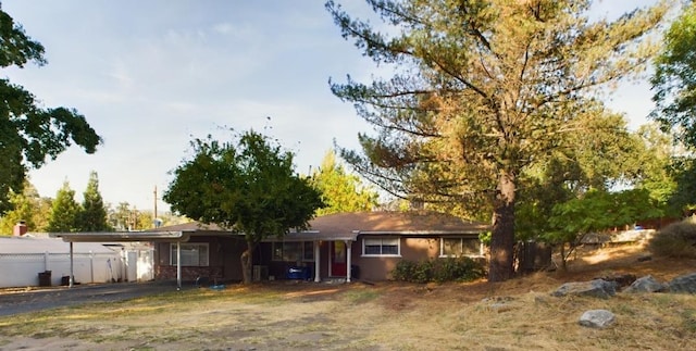 back of house featuring a carport