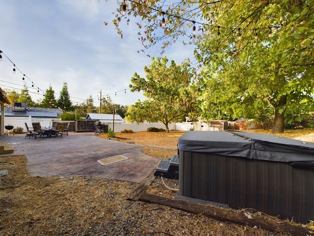 view of yard with a patio and a hot tub