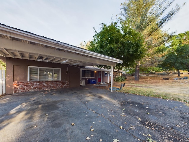 view of property exterior with a carport