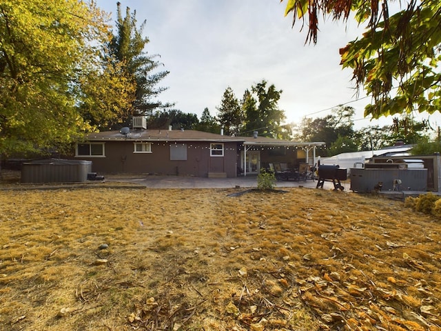 back of house with a patio