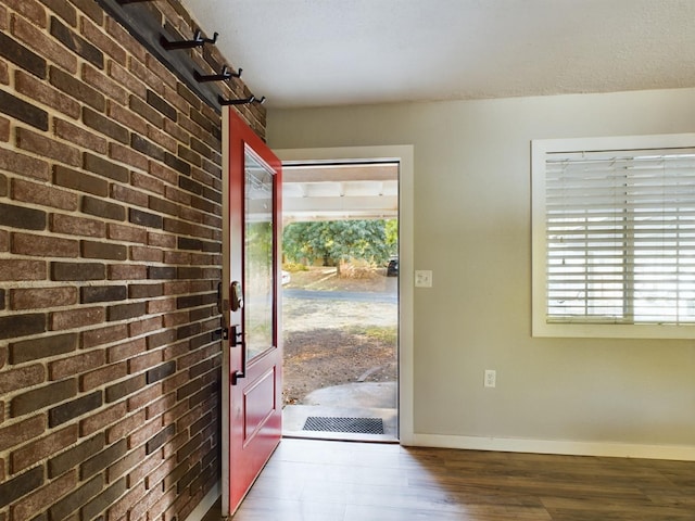 entrance foyer with a textured ceiling and dark wood-type flooring