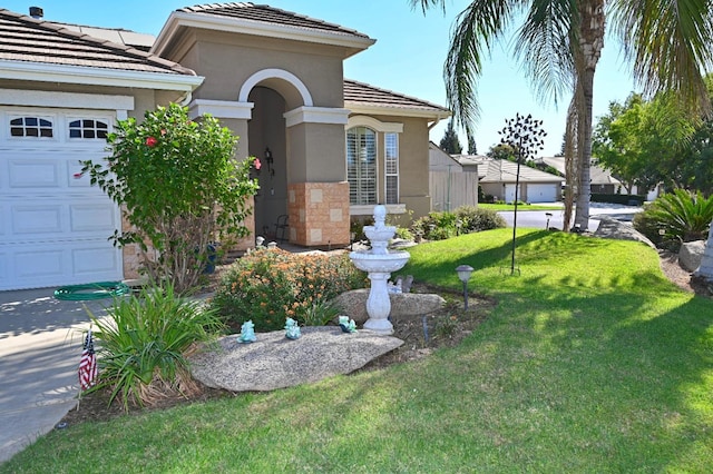 view of front of property featuring a garage and a front yard