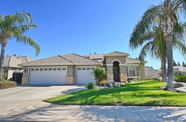 view of front of house featuring a front lawn and a garage