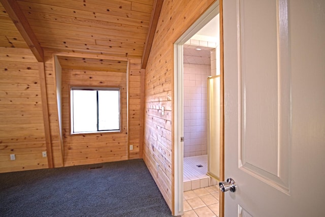 bonus room with wood walls, lofted ceiling with beams, light tile patterned floors, and wooden ceiling