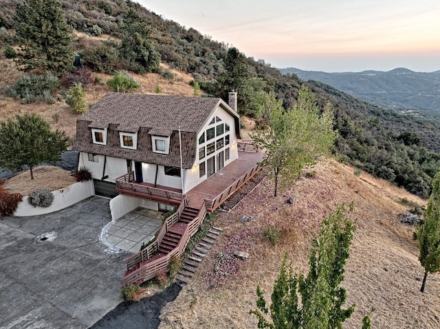 aerial view at dusk featuring a mountain view