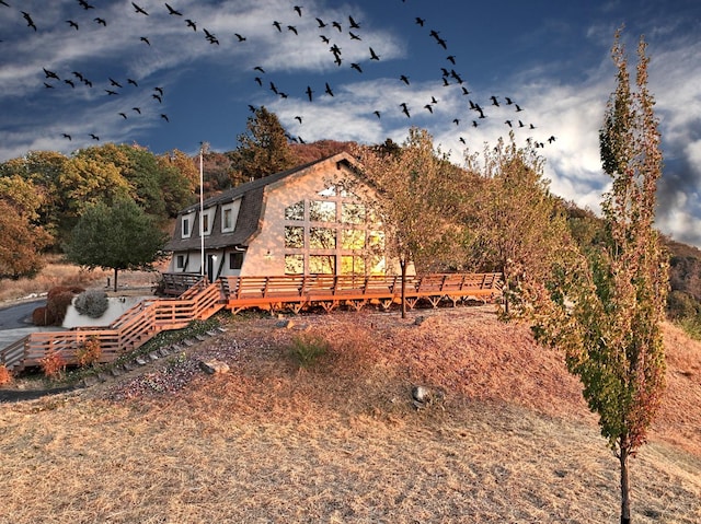 rear view of property with a deck