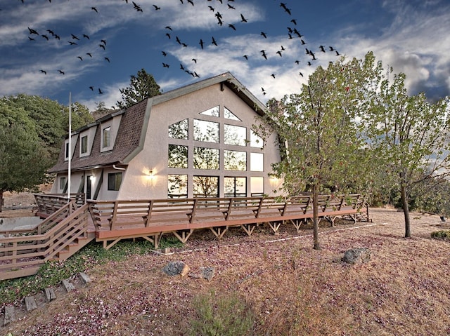 rear view of property with a wooden deck