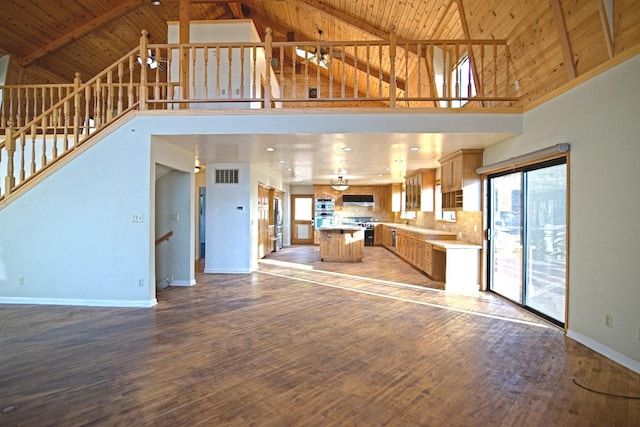 unfurnished living room featuring wood ceiling, wood-type flooring, and high vaulted ceiling