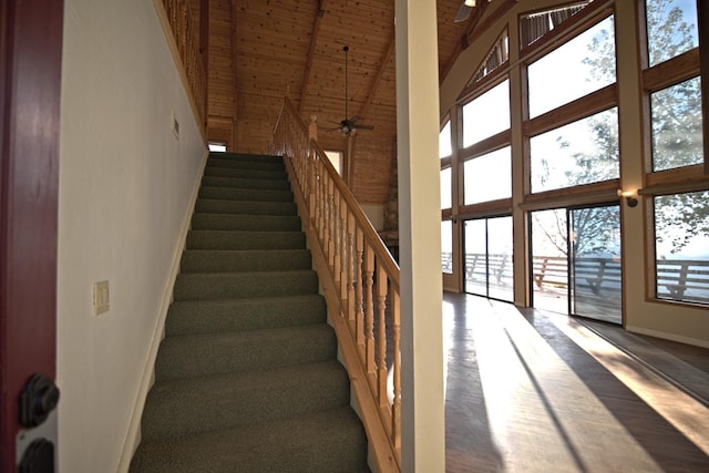 stairs featuring wood ceiling, high vaulted ceiling, and ceiling fan