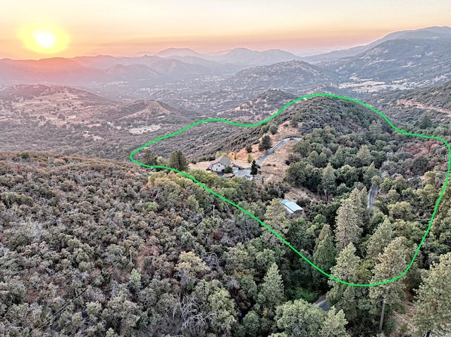 aerial view at dusk featuring a mountain view