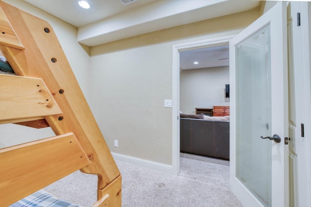 hallway featuring light colored carpet