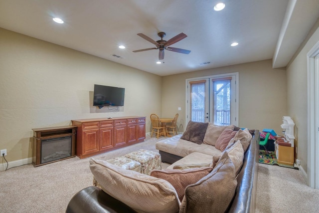 living room with light carpet and ceiling fan