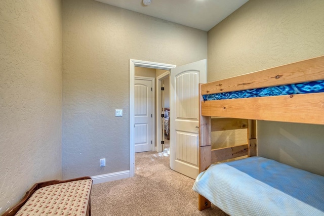 bedroom featuring light colored carpet