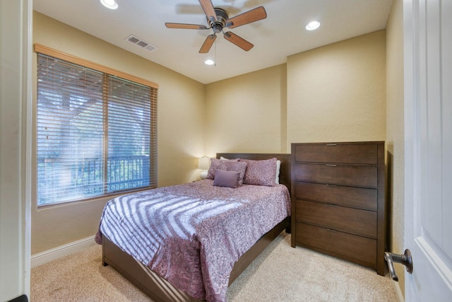 bedroom with light colored carpet and ceiling fan