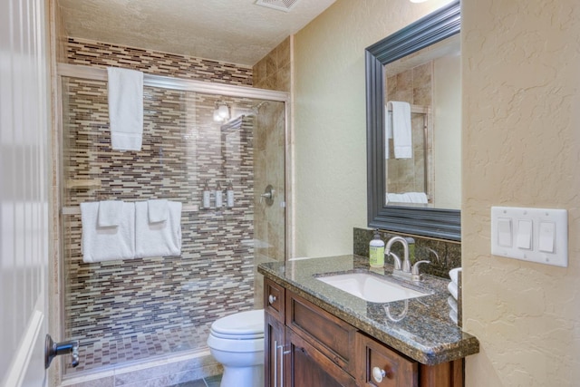 bathroom featuring toilet, an enclosed shower, tile patterned floors, vanity, and a textured ceiling