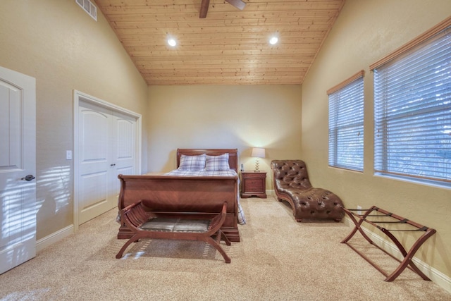 bedroom featuring ceiling fan, a closet, wooden ceiling, and light colored carpet