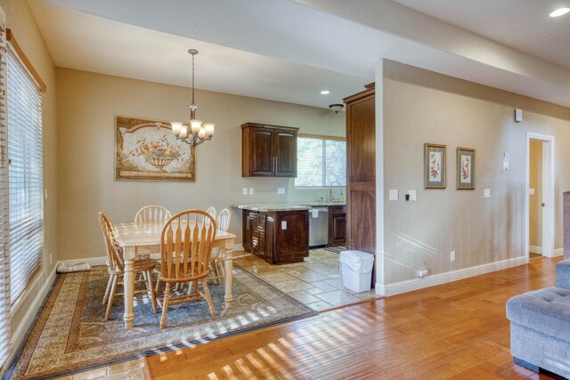 dining area with a chandelier and light hardwood / wood-style flooring