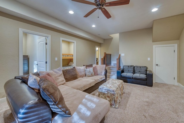 living room featuring ceiling fan and light colored carpet