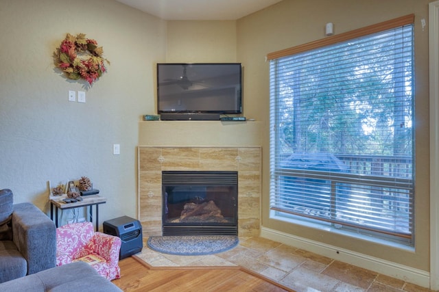 living room featuring hardwood / wood-style flooring and a tiled fireplace