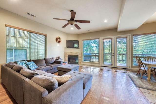 living room with light wood-type flooring and ceiling fan