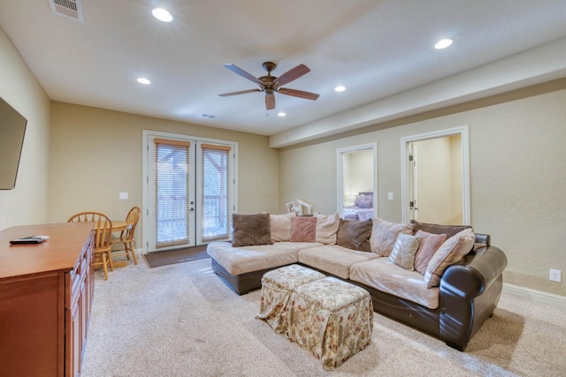 living room with light colored carpet and ceiling fan