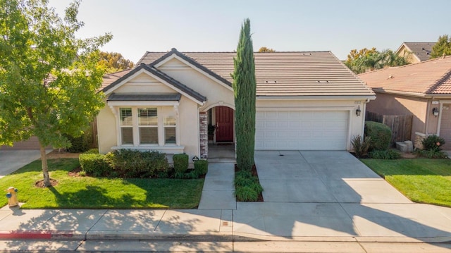 view of front of home with a front yard and a garage