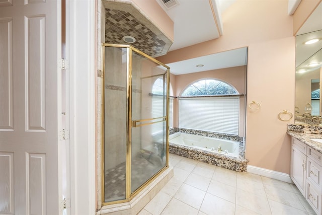 bathroom with vanity, tile patterned floors, and plus walk in shower