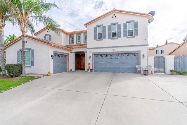 mediterranean / spanish home featuring a garage