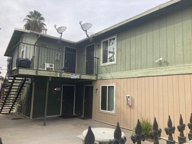 back of house with a patio and a balcony