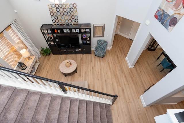 interior space featuring hardwood / wood-style floors and a high ceiling