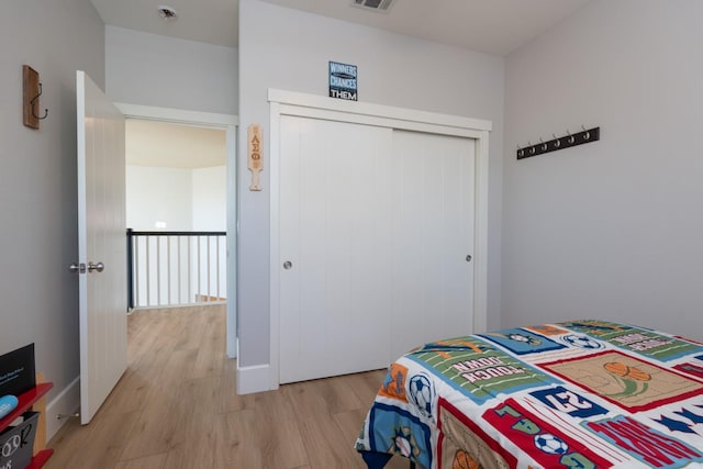 bedroom featuring a closet and light wood-type flooring