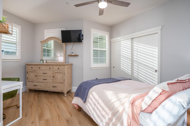 bedroom with a closet, ceiling fan, and light wood-type flooring