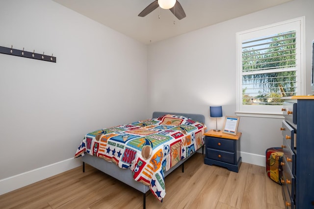 bedroom with light hardwood / wood-style flooring and ceiling fan