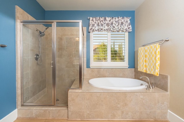 bathroom featuring shower with separate bathtub