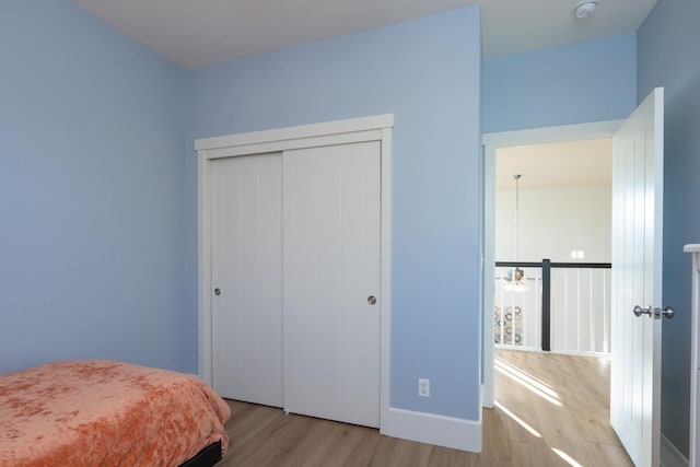 bedroom with a closet and light wood-type flooring