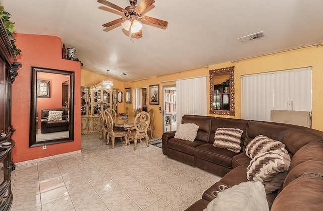 living room featuring ceiling fan and lofted ceiling