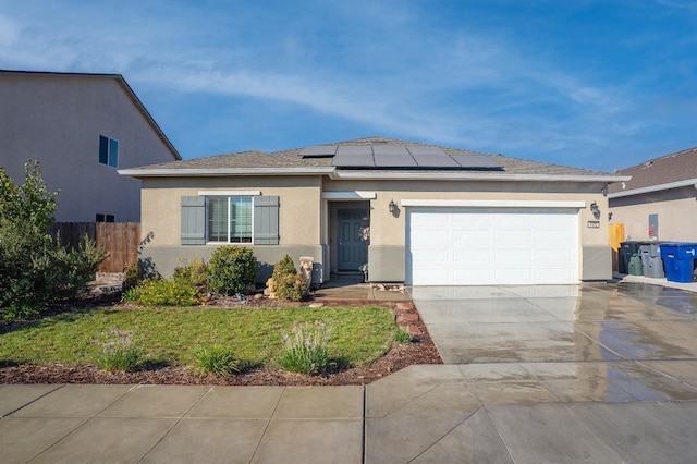 view of front of house featuring solar panels and a garage