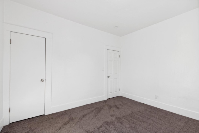 carpeted spare room with baseboards