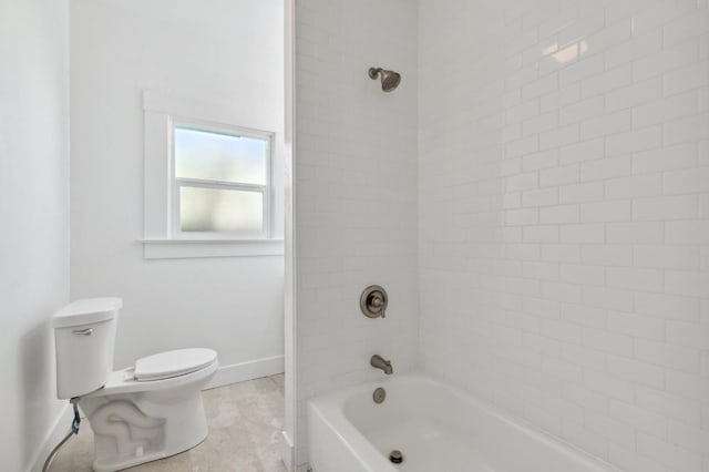 full bathroom featuring washtub / shower combination, toilet, and baseboards